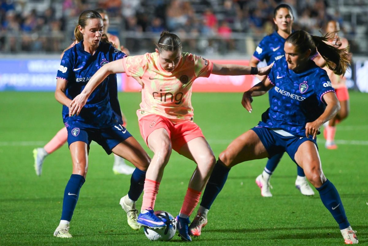 Midfielder Dani Weatherholt and midfielder Carly Wickenheiser defend Portland Thorns midfielder Olivia Moultrie during the game between the North Carolina Courage and Portland Thorns at First Horizon Stadium on Saturday, Apr. 4, 2026. Courage tied the thorns 2-2.
