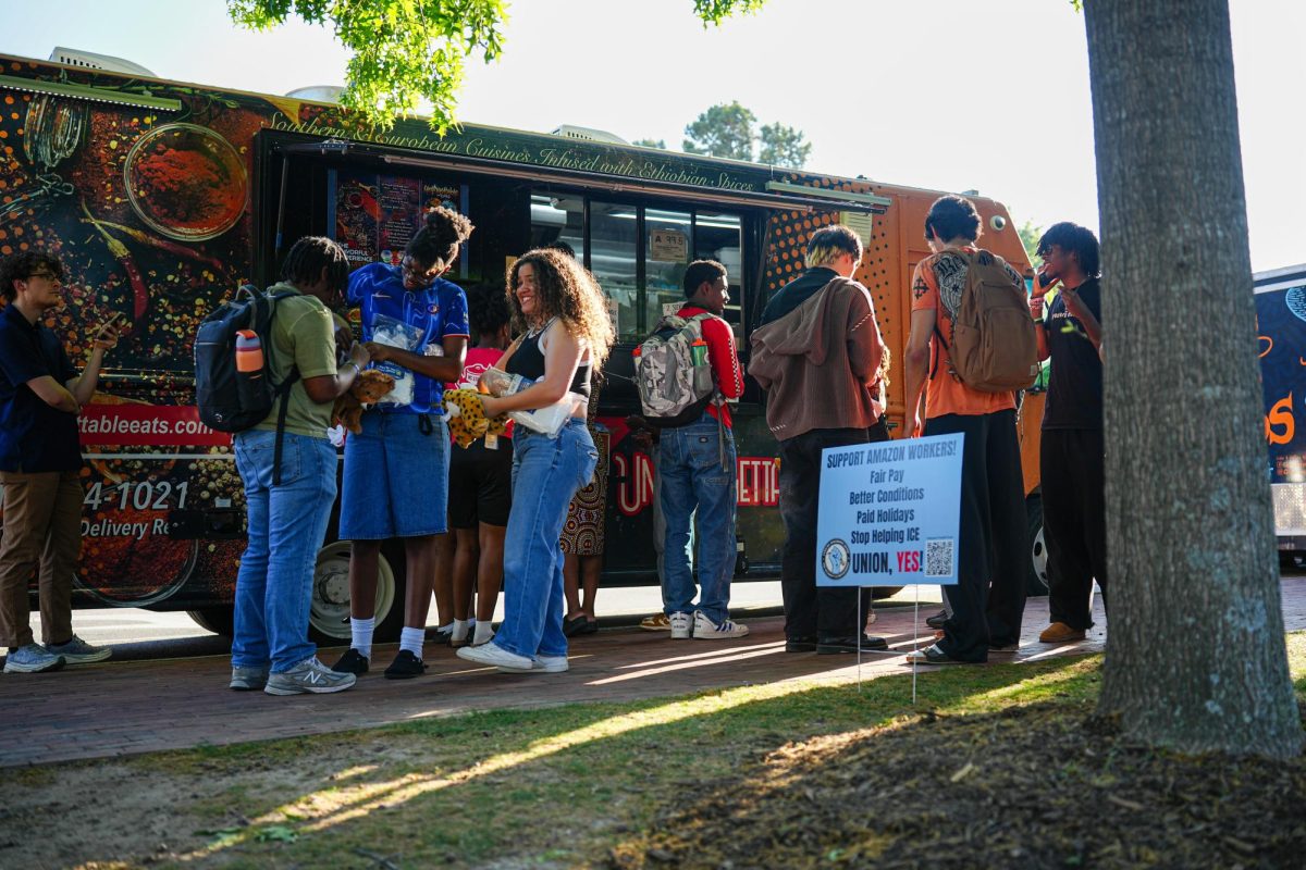 Students wait for their orders at a food truck during the Pan-Afrikan Cookout at Harris Field on Thursday, April 16, 2026. The University Activities Board hosted the event in collaboration with the Black Students Board at N.C. State.