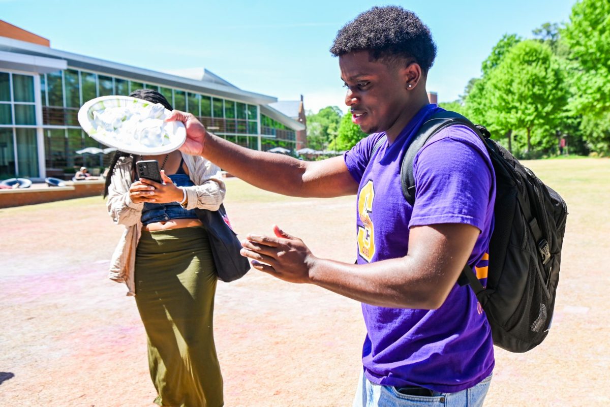 Ryan Bolton, a fourth-year student studying computer engineering, raises a plate during the Pie BSB Eboard event at Stafford Commons on Tuesday, April. 17, 2026. The pie the Black Student Board Eboard event is part of Pan-African Week, a weeklong celebration of Pan-Africanism that promotes unity among students through fun activities designed for the black community.