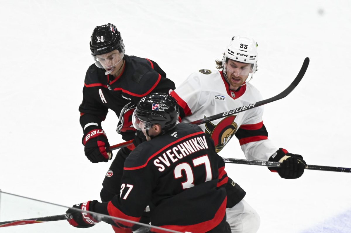 Center Sebastian Aho and right wing Andrei Svechnikov battle an opponent during the round one playoff game versus the Ottawa Senators at the Lenovo Center on Monday, April 20, 2026. Aho scored one goal for the Hurricanes. The Hurricanes beat the Senators 3-2 in double overtime.