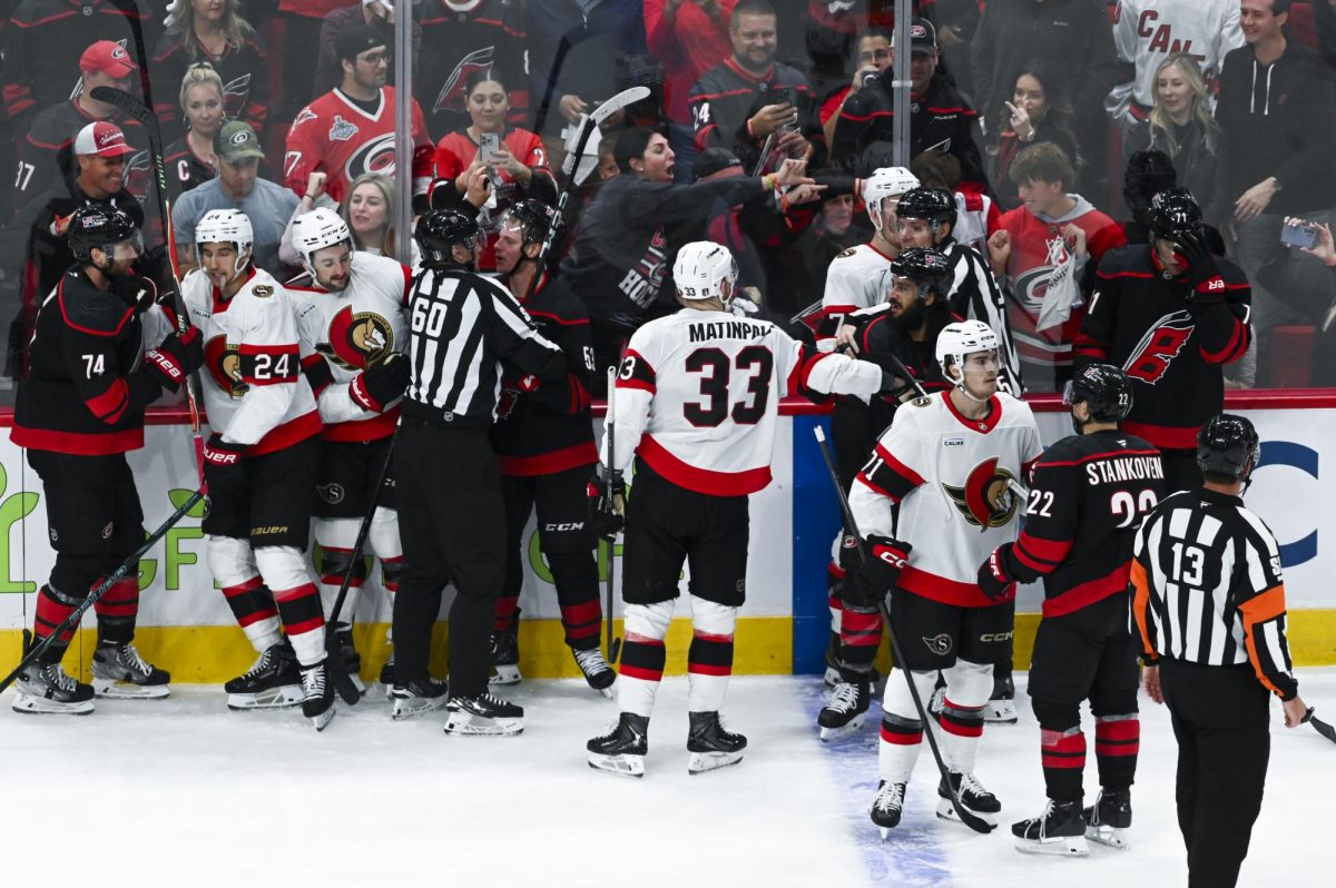 Players from both teams are pulled out of a brawl by referees during the round one playoff game versus the Ottawa Senators at the Lenovo Center on Monday, April 20, 2026. The Hurricanes beat the Senators 3-2 in double overtime.