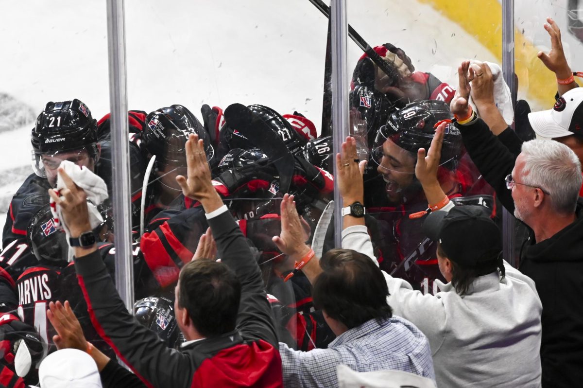 Hurricanes players celebrate after winning the round one playoff game versus the Ottawa Senators at the Lenovo Center on Monday, April 20, 2026. The Hurricanes beat the Senators 3-2 in double overtime.