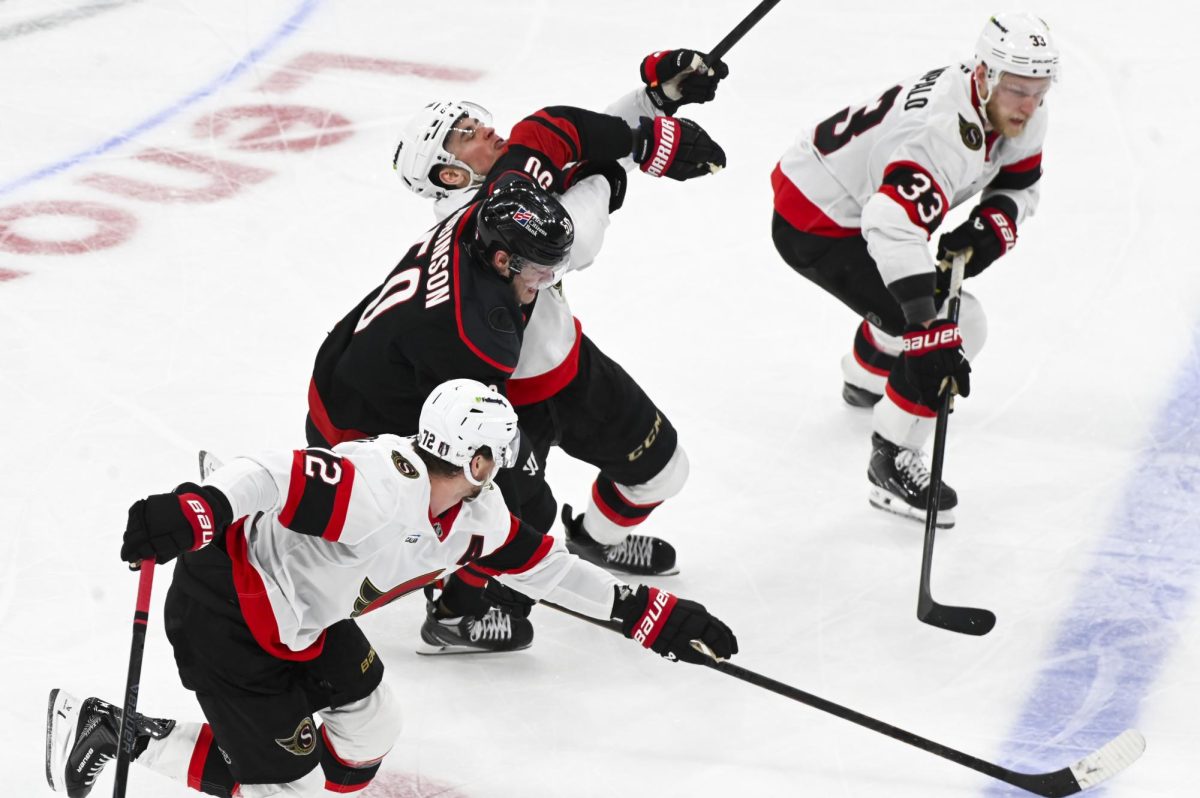 Left wing Eric Robinson pushes through opponents during the round one playoff game versus the Ottawa Senators at the Lenovo Center on Monday, April 20, 2026. The Hurricanes beat the Senators 3-2 in double overtime.