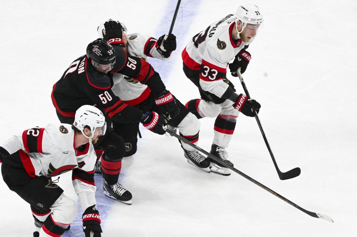 Left wing Eric Robinson pushes through opponents during the round one playoff game versus the Ottawa Senators at the Lenovo Center on Monday, April 20, 2026. The Hurricanes beat the Senators 3-2 in double overtime.