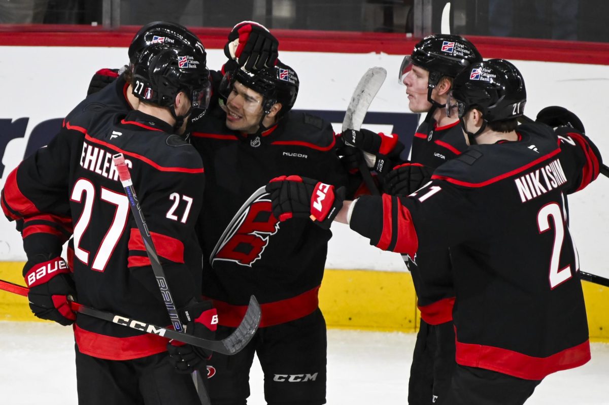 Center Logan Stankoven celebrates with his linemates after scoring a goal during the round one playoff game versus the Ottawa Senators at the Lenovo Center on Monday, April 20, 2026. Stankoven scored one goal for the Hurricanes. The Hurricanes beat the Senators 3-2 in double overtime.