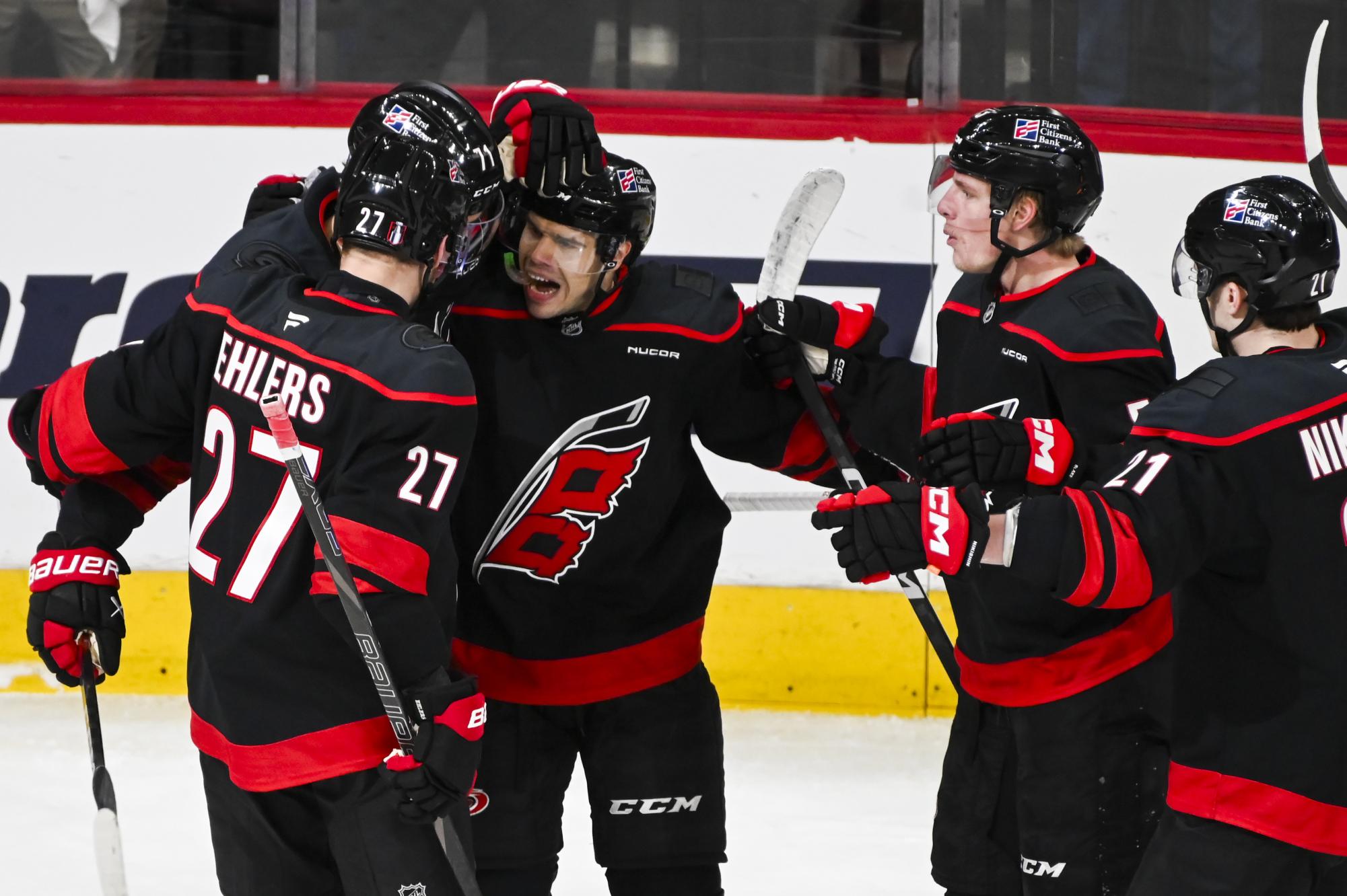 Center Logan Stankoven celebrates with his linemates after scoring a goal during the round one playoff game versus the Ottawa Senators at the Lenovo Center on Monday, April 20, 2026. Stankoven scored one goal for the Hurricanes. The Hurricanes beat the Senators 3-2 in double overtime.