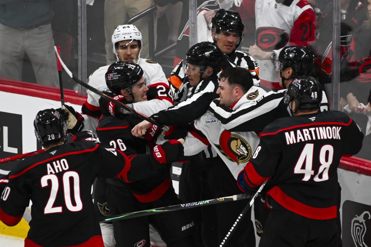 Defenseman Sean Walker fights an opponent during the round one playoff game versus the Ottawa Senators at the Lenovo Center on Monday, April 20, 2026. The Hurricanes beat the Senators 3-2 in double overtime.