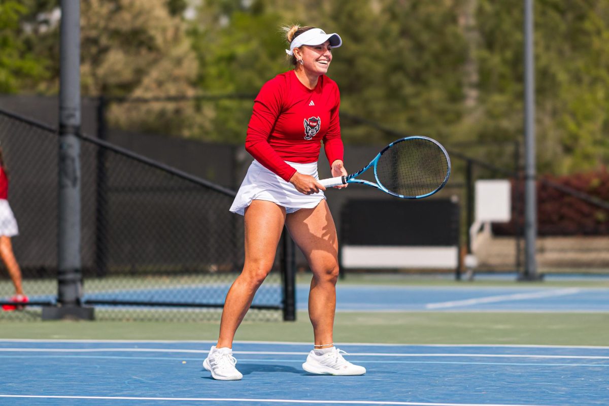 Junior Gabriella Braodfoot smiles after being hit with a ball during warmups before the match against Duke at Cary Tennis Park on Wednesday, April 8, 2026. The Wolfpack fell to the Blue Devils 3-4.