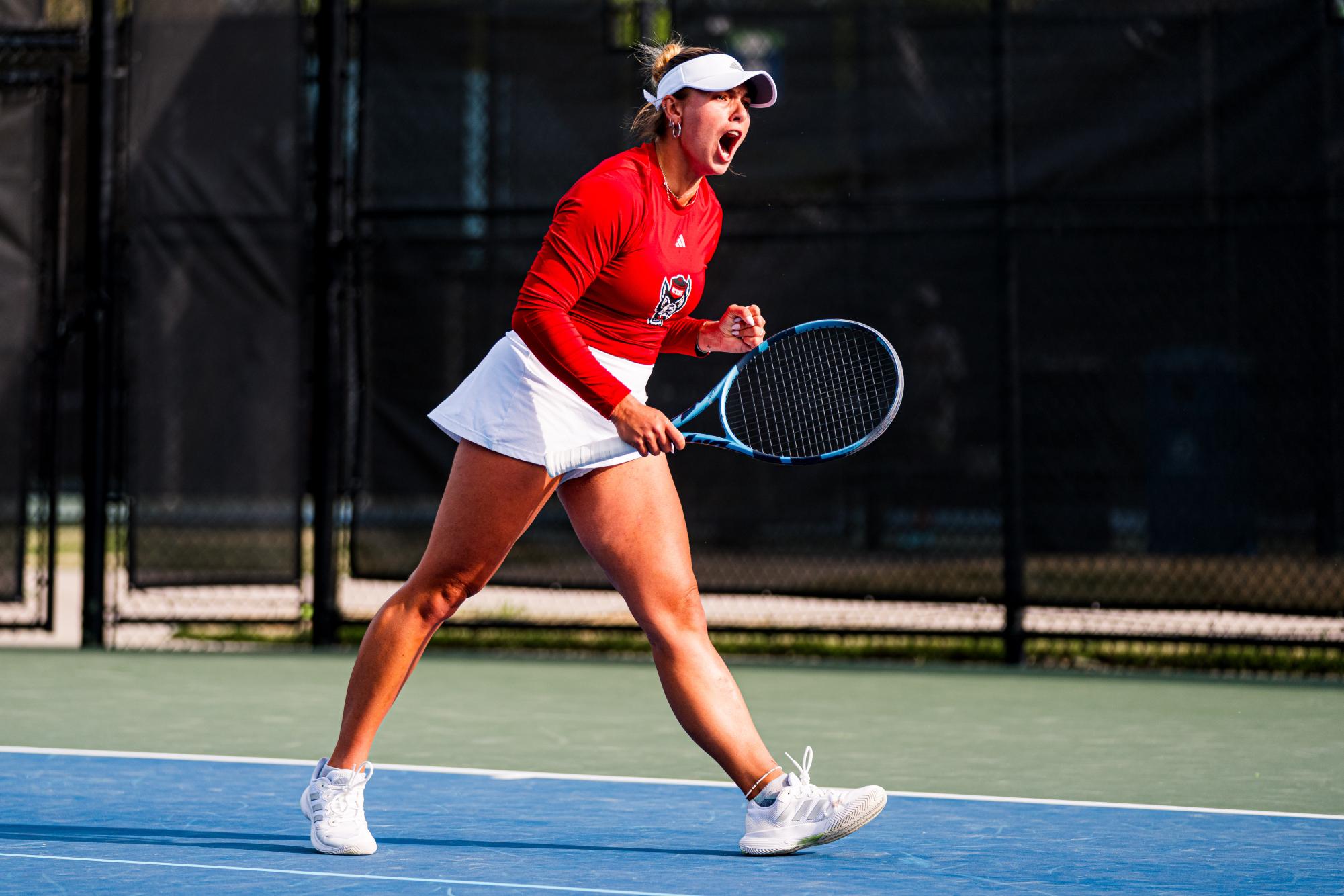 Junior Gabriella Braodfoot screams after scoring a point during the match against Duke at Cary Tennis Park on Wednesday, April 8, 2026. Braodfoot lost her singles match 7-6,3-6,2-6. The Wolfpack fell to the Blue Devils 3-4.
