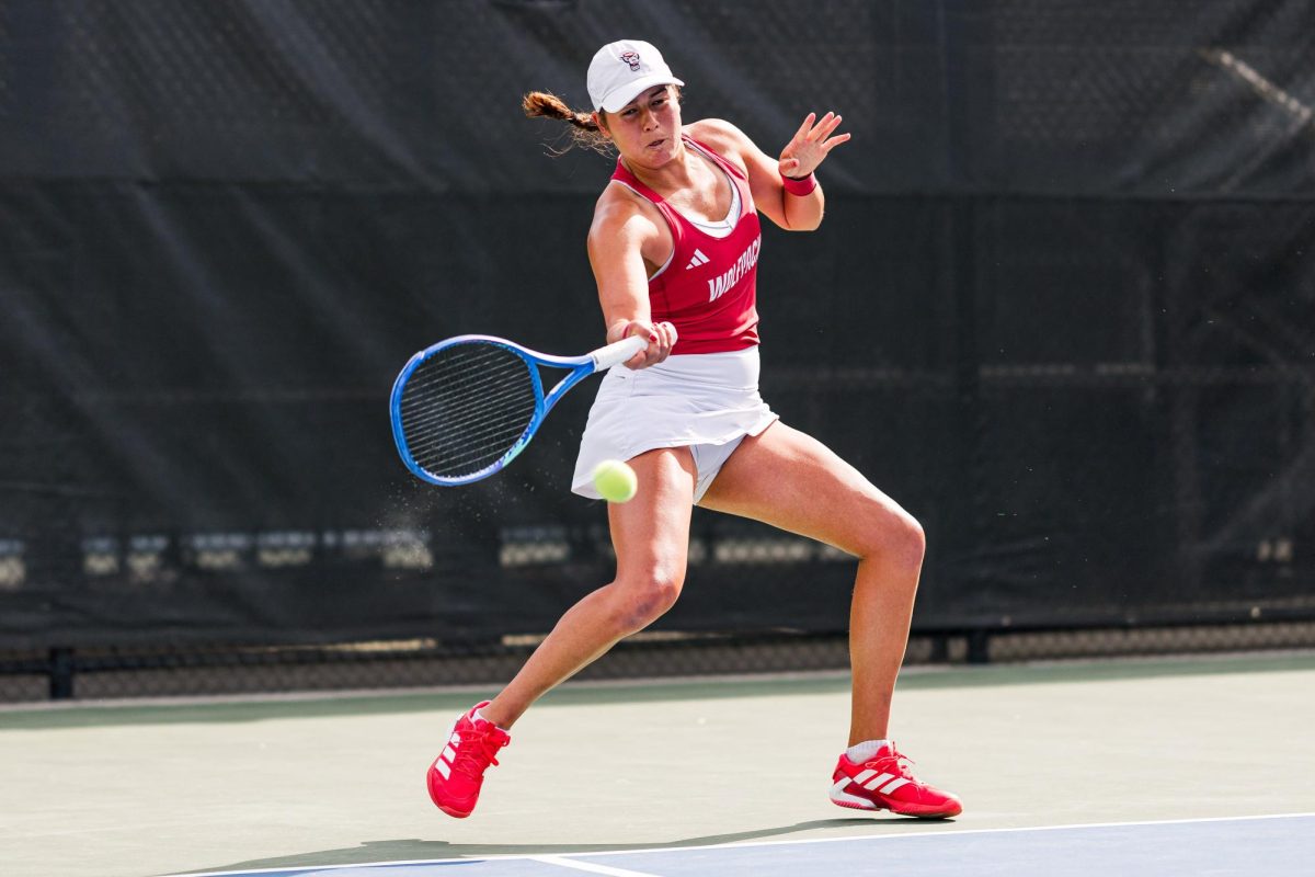 Sophomore Mia Slama lunges down to hit the ball during her match against Duke at Cary Tennis Park on Wednesday, April 8, 2026. Slama lost her singles match 5-7,1-6. The Wolfpack fell to the Blue Devils 3-4.