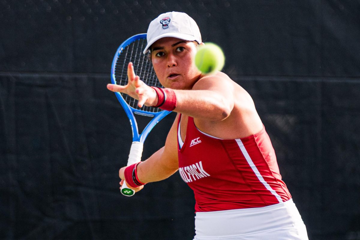 Sophomore Mia Slama watches the ball before hitting it during her match against Duke at Cary Tennis Park on Wednesday, April 8, 2026. Slama lost her singles match 5-7,1-6. The Wolfpack fell to the Blue Devils 3-4.