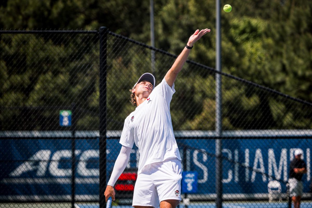 Senior Martin Borisiouk tosses up the ball while serving during his singles match against Florida State in the second round of the ACC Men's Tennis Championship at Cary Tennis Park on Thursday, April 16, 2026. Borisiouk won his singles match 4-6,6-3,6-4. The Wolfpack lost to the Seminoles 3-4.