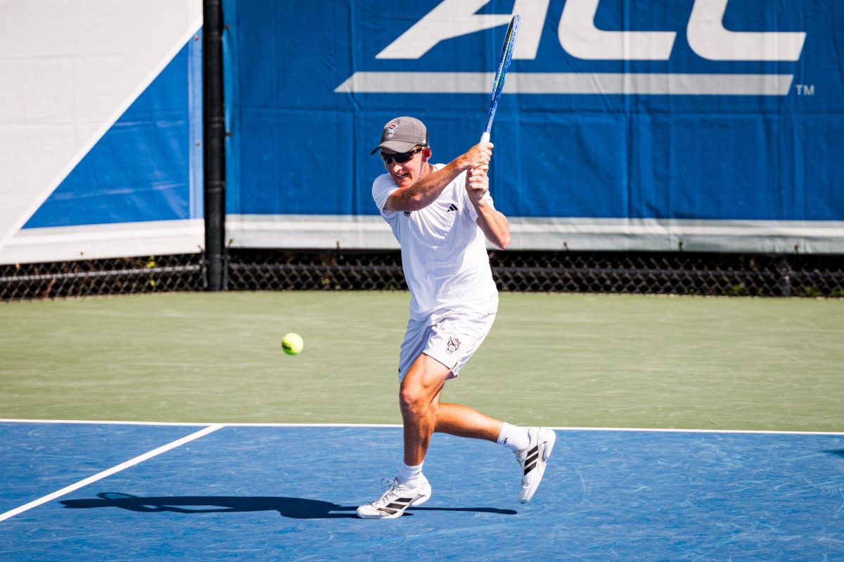 Freshman Charlie Camus hits the ball back during his singles match against Florida State in the second round of the ACC Men's Tennis Championship at Cary Tennis Park on Thursday, April 16, 2026. The Wolfpack lost to the Seminoles 3-4.