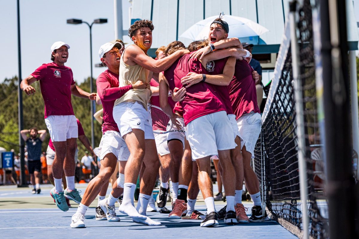 Florida State players celebrate Gabor Hornung winning his singles match against NC State in the second round of the ACC Men's Tennis Championship at Cary Tennis Park on Thursday, April 16, 2026. The Wolfpack lost to the Seminoles 3-4.