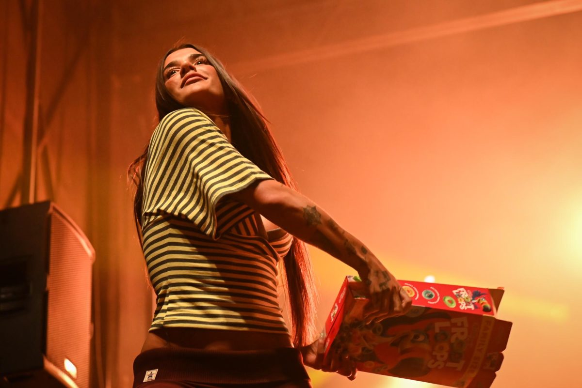 Internet personality Ari Kytsya throws Froot Loops into the crowd during the Wolfstock concert on Miller Fields on Saturday, April 18, 2026. Wolfstock is NC State's spring concert which includes activities, food, and a concert to close the night. 