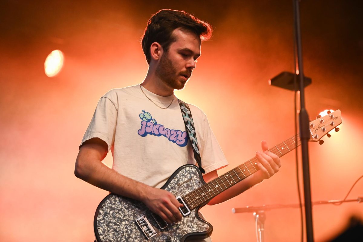 Odd 39 guitarist Drew Scott, a fourth year in the College of Engineering, performs during the Wolfstock concert on Miller Fields on Saturday, April 18, 2026. Odd 39 opened for the Wolfstock concert, which also featured K-CAMP and Yung Gravy. 
