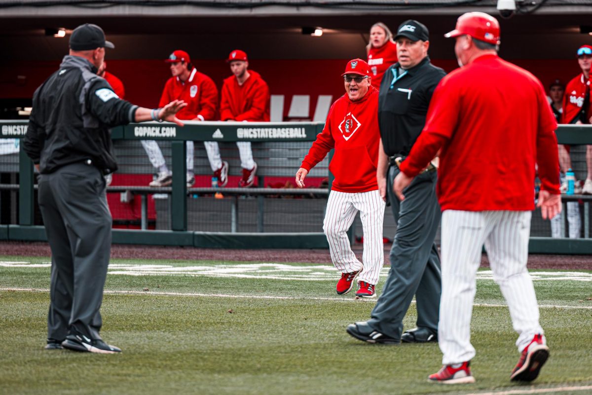 Head Coach Elliot Avent comes out to the field to argue a call during the first game of the doubleheader against Miami in Doak Field at Dail Park on Friday, May 1, 2026. The Wolfpack lost to the Hurricanes 12-9.