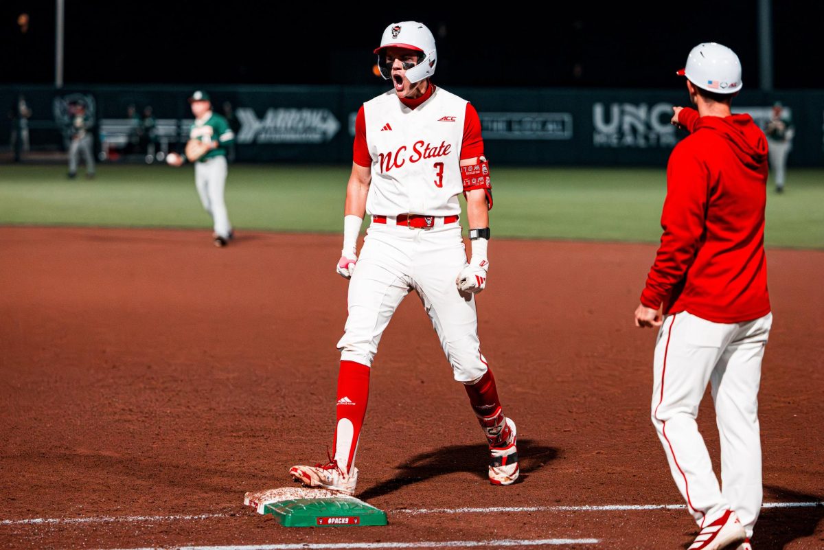 Freshman infielder Christian Serrano reacts to the dugout after getting a hit during the game against Miami in Doak Field at Dail Park on Saturday, May 2, 2026. The Wolfpack defeated the Hurricanes 12-7.
