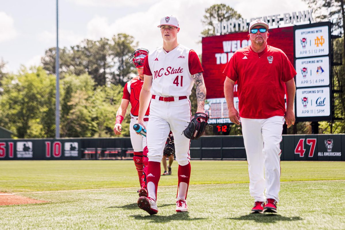 Junior right-hand pitcher Jacob Dudan walks up to the dugout before the game against Notre Dame at Doak Field at Dail Park on Saturday, April 4, 2026. Dudan recorded six strikeouts. NC State defeated Notre Dame 7-6.
