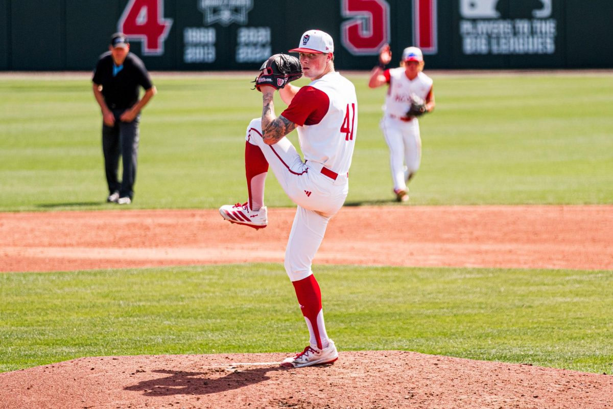 Junior right-hand pitcher Jacob Dudan winds up before pitching during the game against Notre Dame at Doak Field at Dail Park on Saturday, April 4, 2026. Dudan recorded six strikeouts. NC State defeated Notre Dame 7-6.