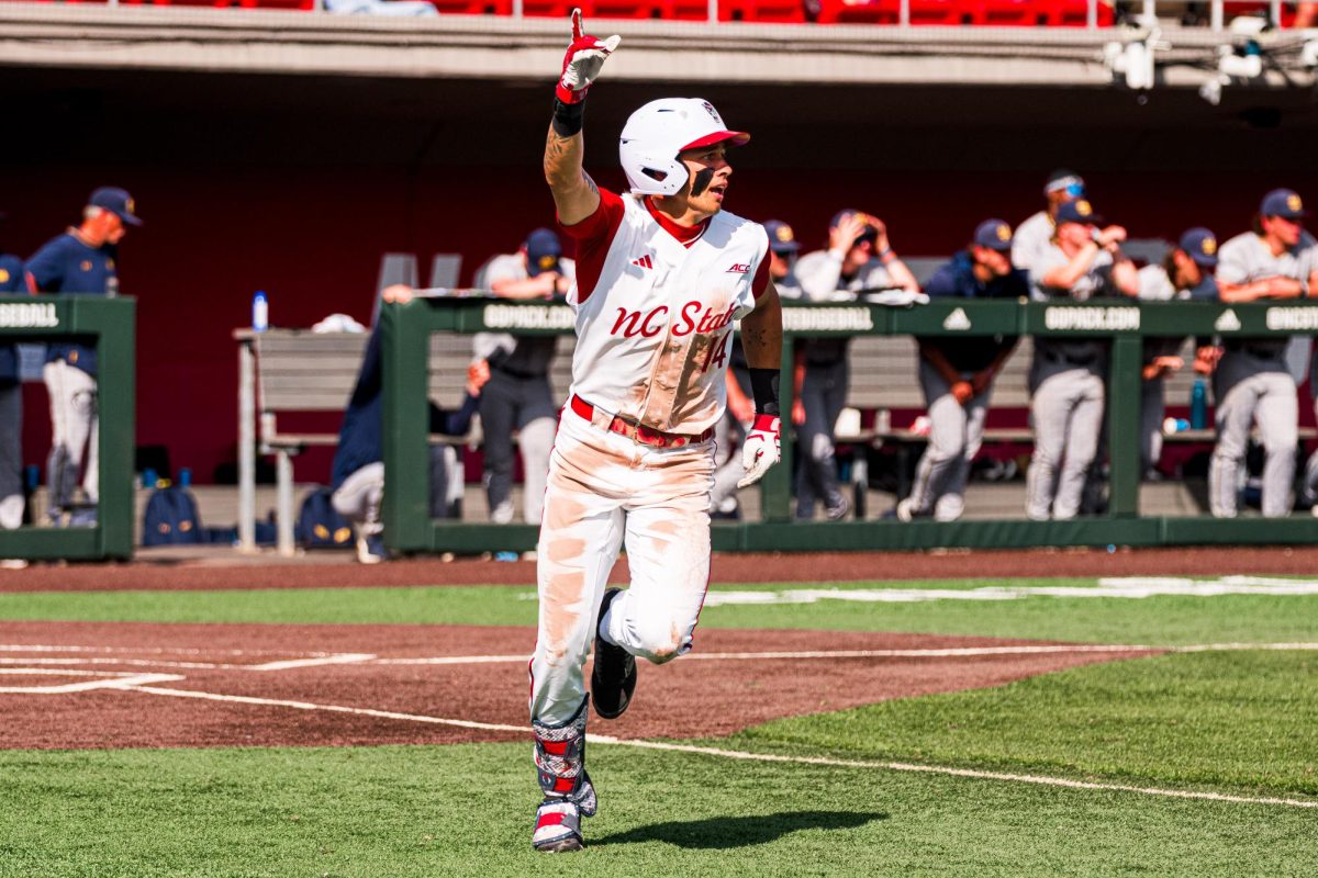 Sophomore outfielder Ty Head puts his hand in the air to score the go-ahead run to win the game against Notre Dame at Doak Field at Dail Park on Saturday, April 4, 2026. NC State defeated Notre Dame 7-6.