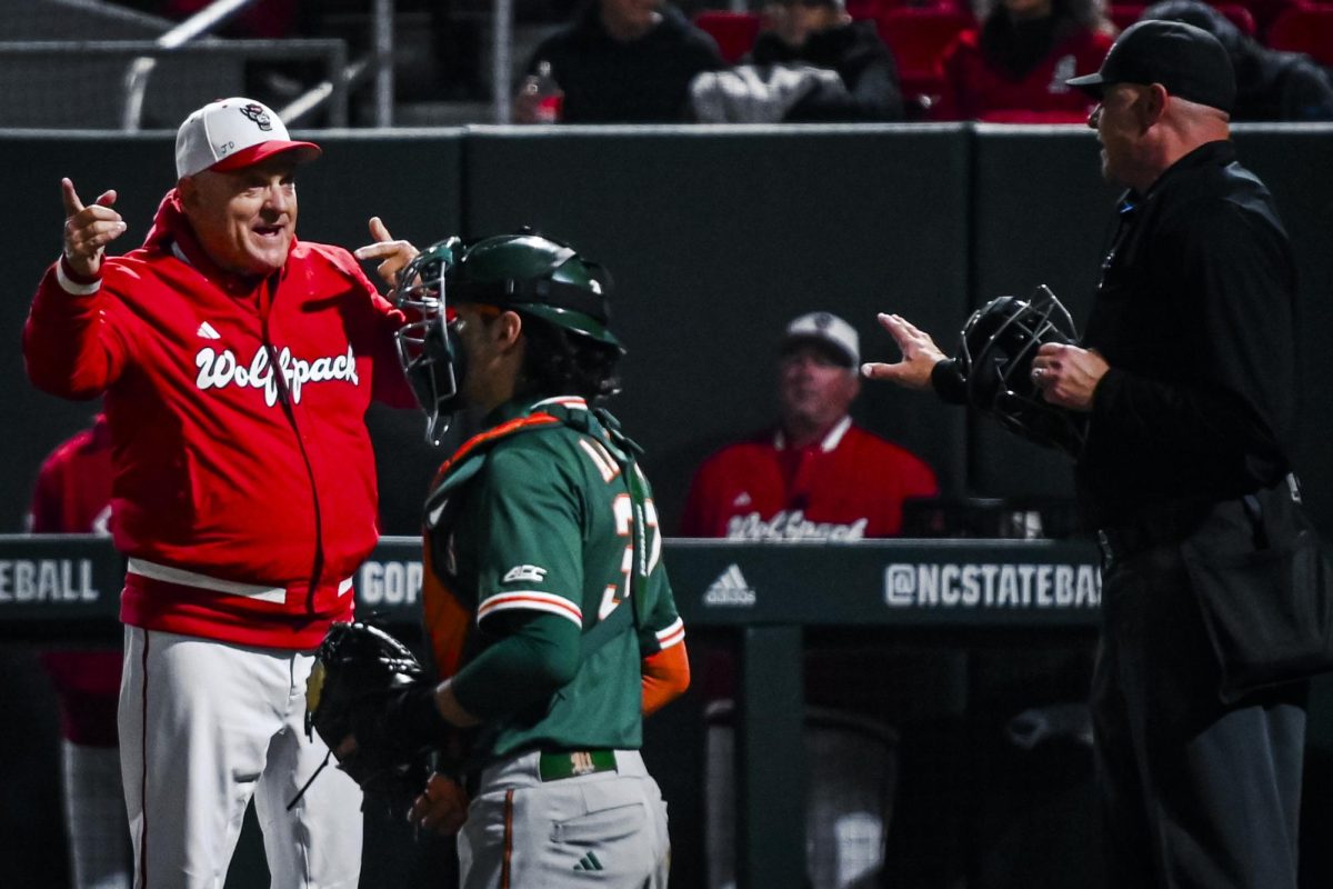 Head coach Elliott Avent argues with the umpire during the game against Miami in Doak Field at Dail Park on Saturday, May 2, 2026. The Wolfpack defeated the Hurricanes 12-7.