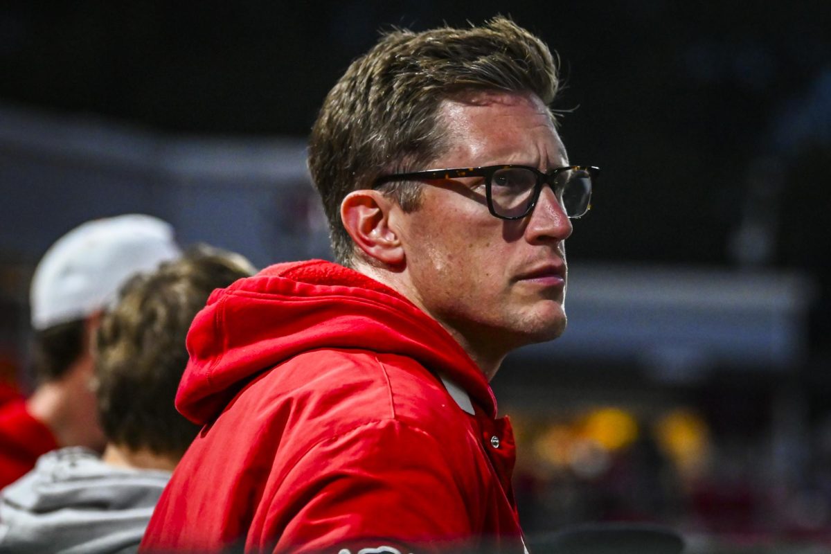 Athletic trainer Scott Ensell watches a play in review on the big screen during the game against Miami in Doak Field at Dail Park on Saturday, May 2, 2026. The Wolfpack defeated the Hurricanes 12-7.