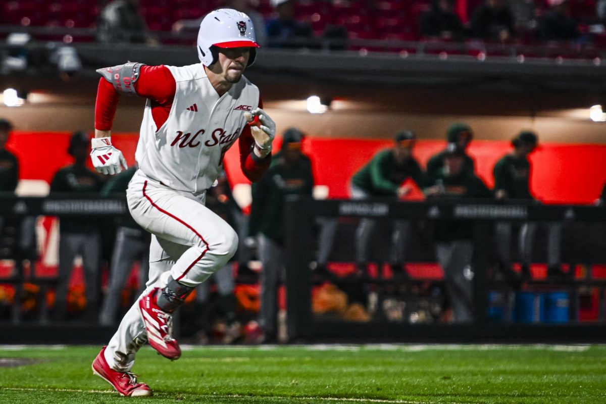 Redshirt-junior catcher Drew Lanphere sprints to first during the game against Miami in Doak Field at Dail Park on Saturday, May 2, 2026. The Wolfpack defeated the Hurricanes 12-7.