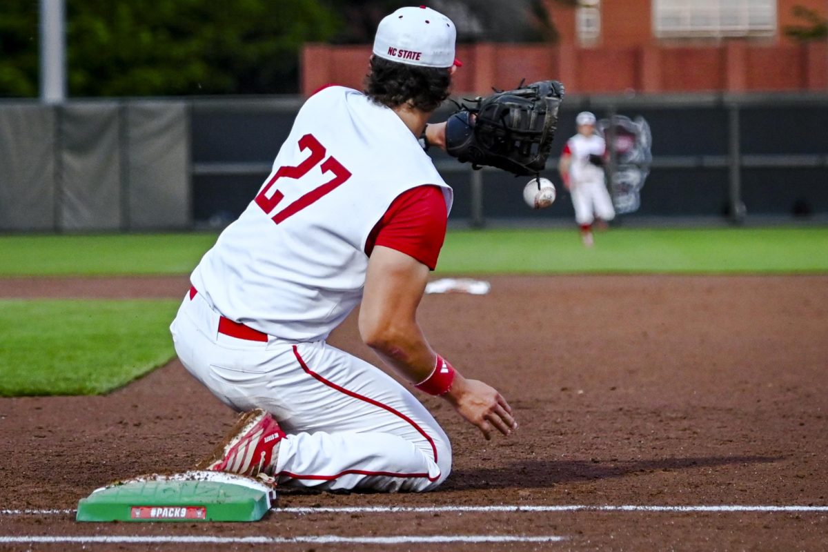 Junior infielder Chris McHugh catches the ball for an out on first during the game against Miami in Doak Field at Dail Park on Saturday, May 2, 2026. The Wolfpack defeated the Hurricanes 12-7.