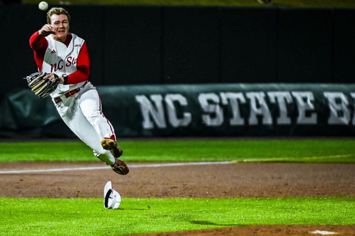 Senior infielder Wyatt Peifer launches the ball to first during the game against Miami in Doak Field at Dail Park on Saturday, May 2, 2026. The Wolfpack defeated the Hurricanes 12-7.