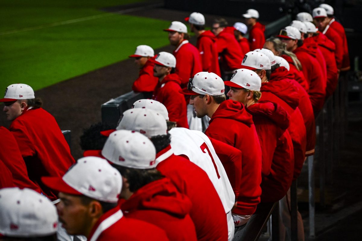 Wolfpack players watch from the dugout during the game against Miami in Doak Field at Dail Park on Saturday, May 2, 2026. The Wolfpack defeated the Hurricanes 12-7.