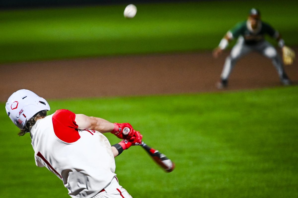 Freshman outfielder Rett Johnson strikes the ball during the game against Miami in Doak Field at Dail Park on Saturday, May 2, 2026. The Wolfpack defeated the Hurricanes 12-7.