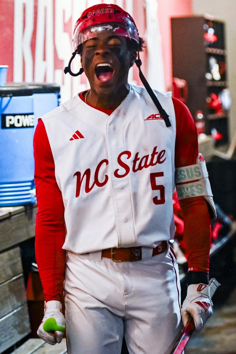 Junior infielder Sherman Johnson celebrates in the dugout after hitting a homer during the game against Miami in Doak Field at Dail Park on Saturday, May 2, 2026. The Wolfpack defeated the Hurricanes 12-7.