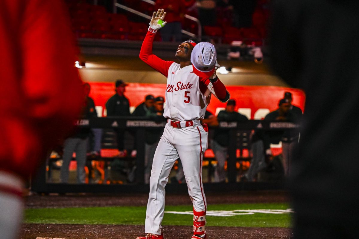 Junior infielder Sherman Johnson raises his hands in celebration after hitting a homer during the game against Miami in Doak Field at Dail Park on Saturday, May 2, 2026. The Wolfpack defeated the Hurricanes 12-7.