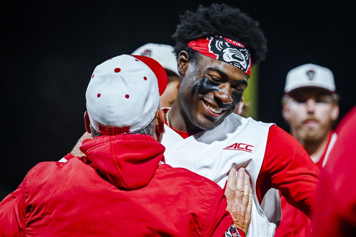 Junior infielder Sherman Johnson hugs head coach Elliott Avent after the game against Miami in Doak Field at Dail Park on Saturday, May 2, 2026. The Wolfpack defeated the Hurricanes 12-7.