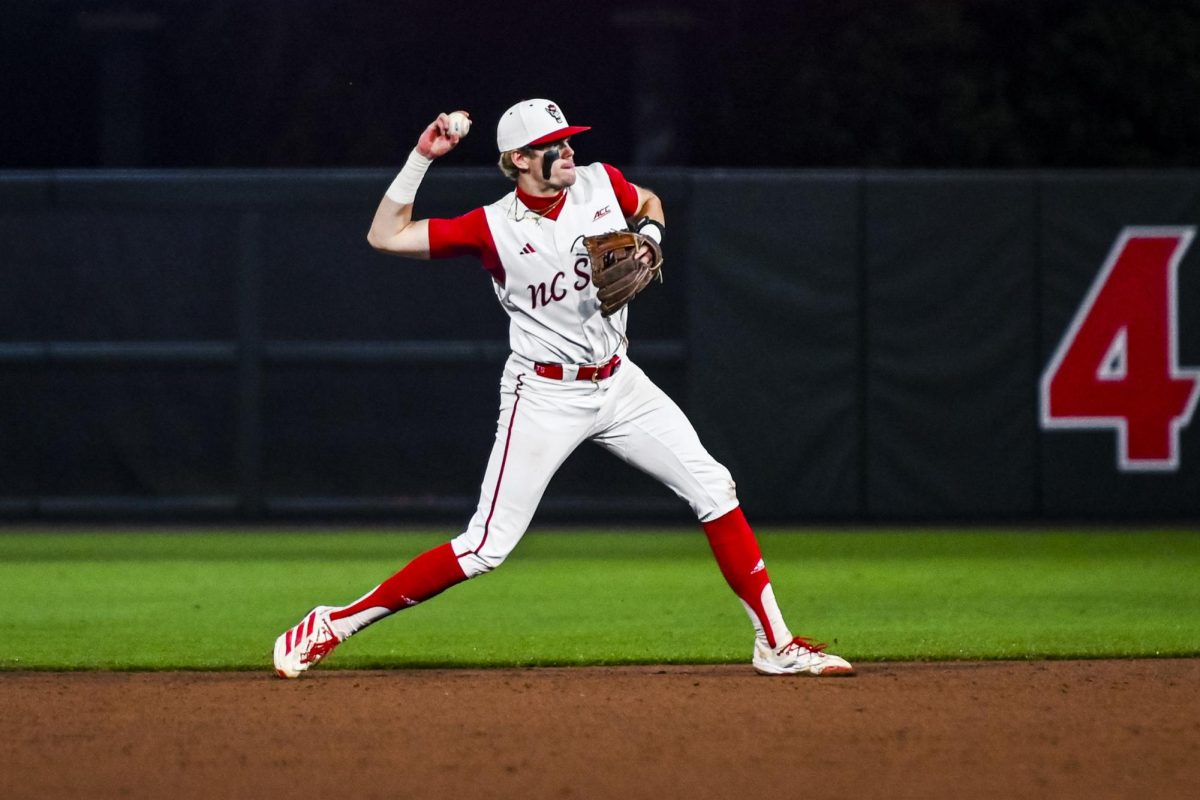Freshman infielder Christian Serrano throws to first during the game against Miami in Doak Field at Dail Park on Saturday, May 2, 2026. The Wolfpack defeated the Hurricanes 12-7.