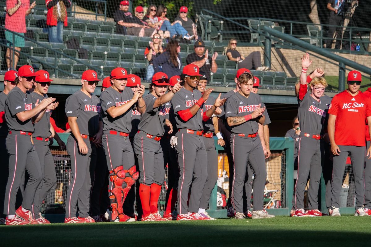 The dugout applauds a homerun by junior infielder Sherman Johnson during the game against Stanford at Klein Field at Sunken Diamond on Friday, May 8, 2026. The Wolfpack fell to the Cardinal 6-5. 