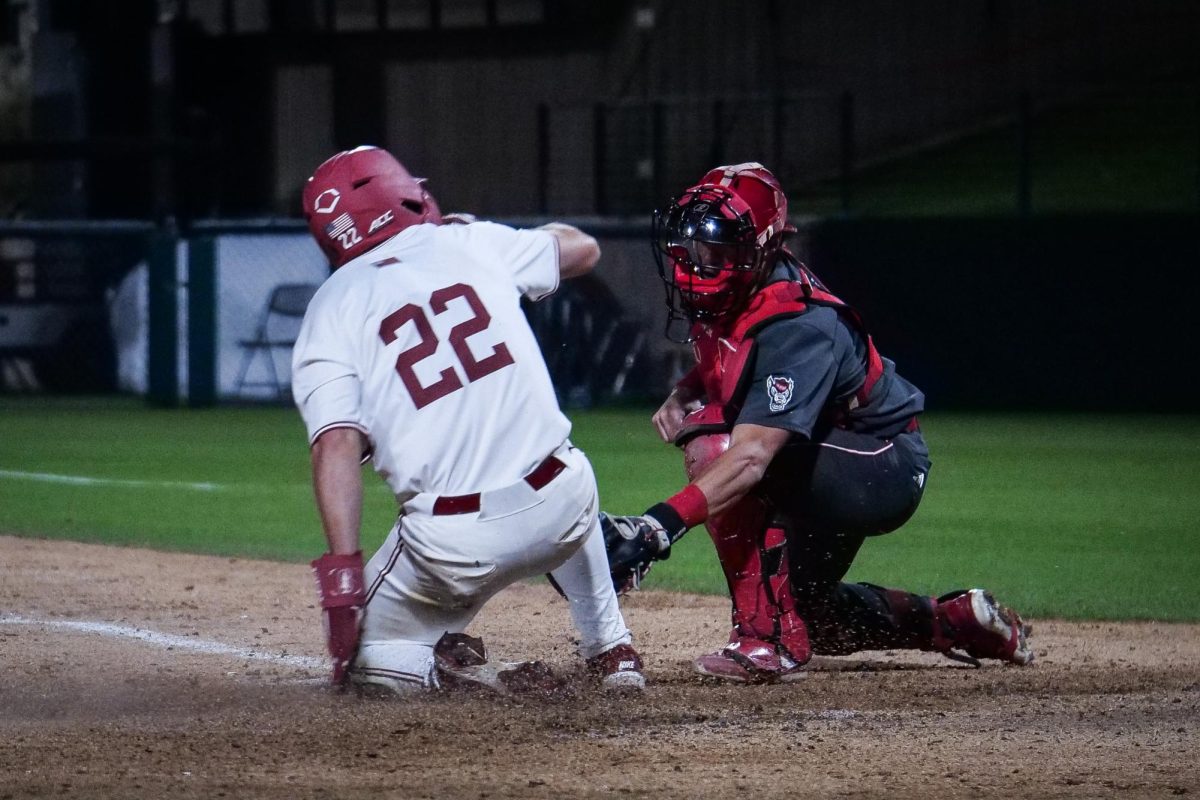Senior outfielder Cort MacDonald sneaks into home before the tag by redshirt junior Drew Lanphere during the game against NC State at Klein Field at Sunken Diamond on Friday, May 8, 2026. The Wolfpack fell to the Cardinal 6-5. 