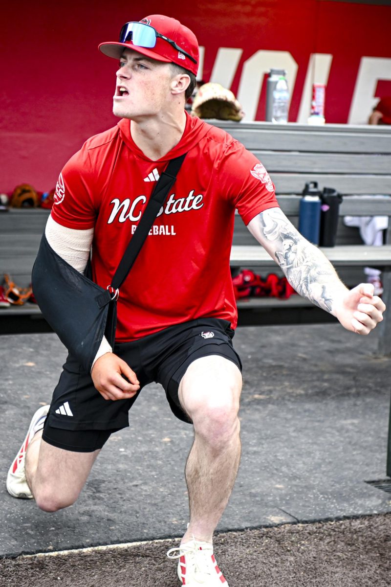 Junior right-hand pitcher Jacob Dudan goofs off in the dugout during the first game of the doubleheader against Miami in Doak Field at Dail Park on Friday, May 1, 2026. The Wolfpack fell to the Hurricanes 12-9.