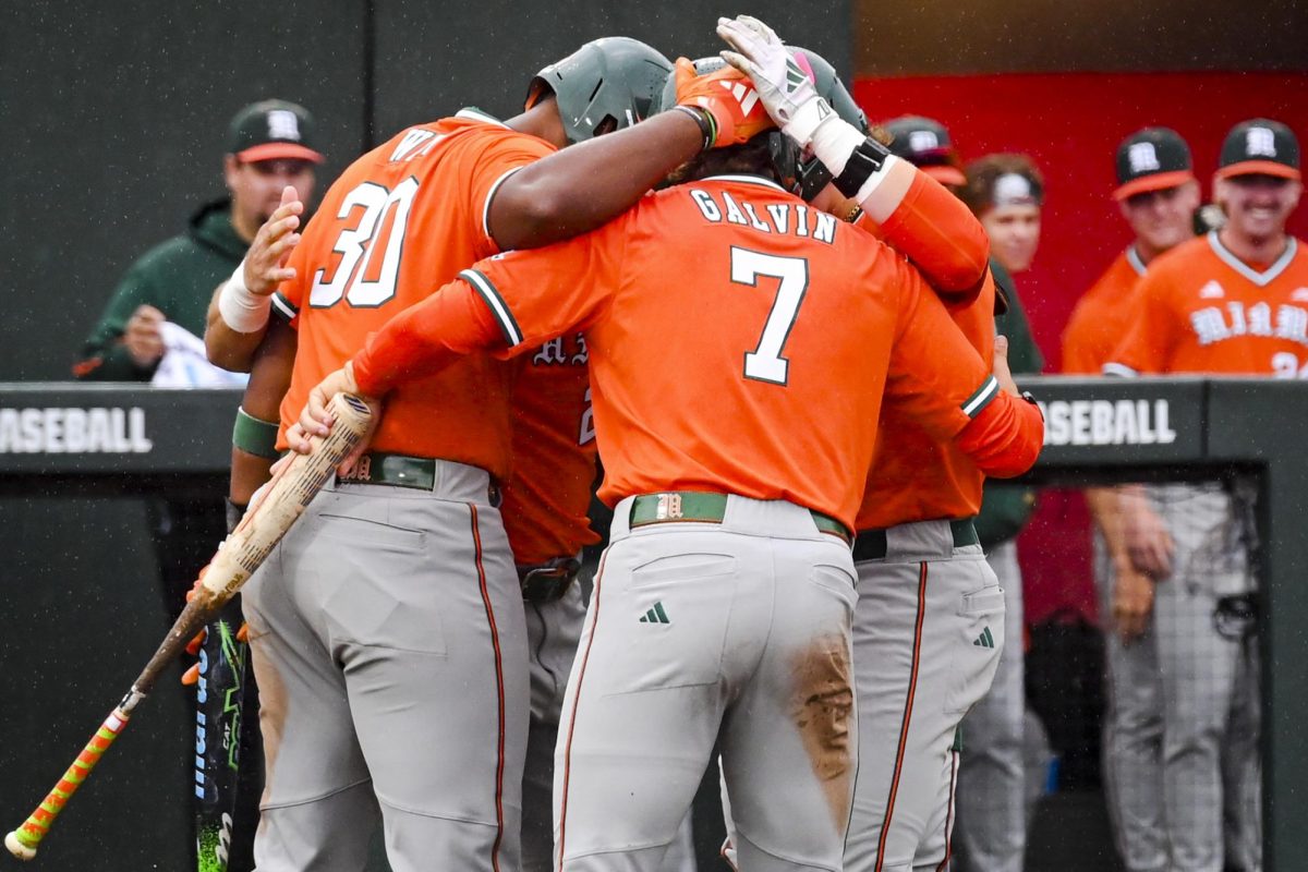 Hurricane players hug after a homerun with runners on base during the first game of the doubleheader against Miami in Doak Field at Dail Park on Friday, May 1, 2026. The Wolfpack fell to the Hurricanes 12-9.