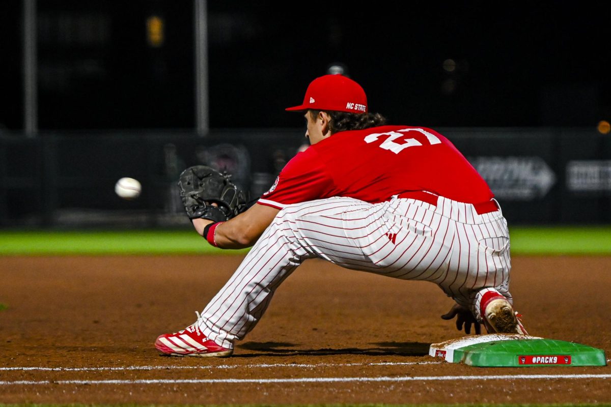 Junior infielder Chris McHugh catches the ball on first during the second game of the doubleheader against Miami in Doak Field at Dail Park on Friday, May 1, 2026. The Wolfpack defeated the Hurricanes 13-6.