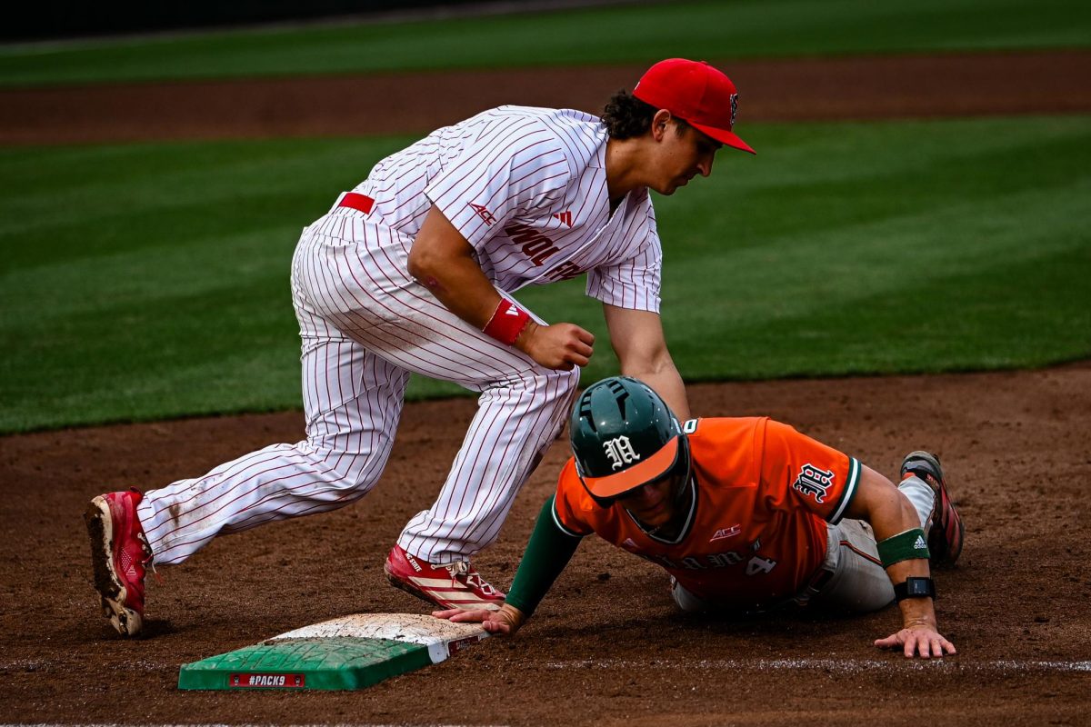 Junior infielder Chris McHugh tags a Miami player in a pickoff during the first game of the doubleheader against Miami in Doak Field at Dail Park on Friday, May 1, 2026. The Hurricanes defeated the Wolfpack 12-9.