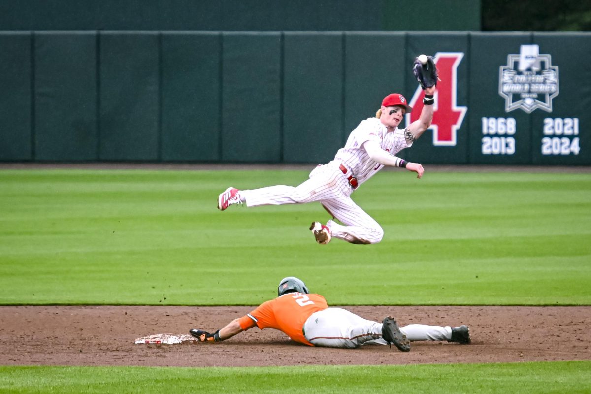 Junior infielder Luke Nixon jumps for a catch during the first game of the doubleheader against Miami in Doak Field at Dail Park on Friday, May 1, 2026. The Wolfpack fell to the Hurricanes 12-9.