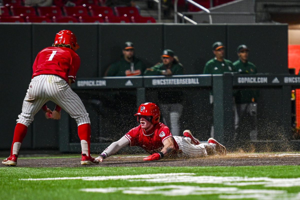 Junior infielder Luke Nixon slides into home plate during the second game of the doubleheader against Miami in Doak Field at Dail Park on Friday, May 1, 2026. The Wolfpack defeated the Hurricanes 13-6.