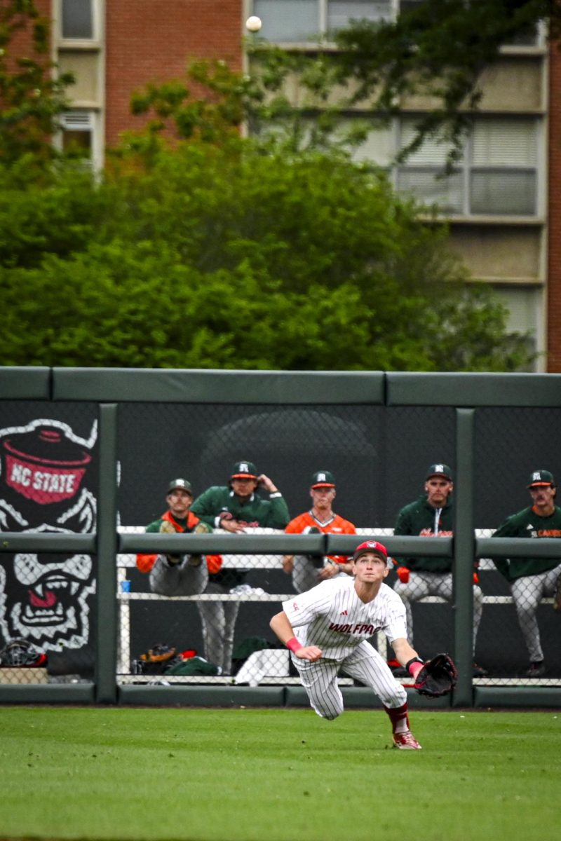 Freshman outfielder Rett Johnson dives to catch a fly ball during the first game of the doubleheader against Miami in Doak Field at Dail Park on Friday, May 1, 2026. The Wolfpack fell to the Hurricanes 12-9.