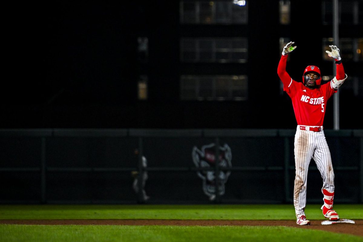 Junior infielder Sherman Johnson gestures to the dugout after hitting a double base hit during the second game of the doubleheader against Miami in Doak Field at Dail Park on Friday, May 1, 2026. Johnson recorded two runs and one hit. The Wolfpack defeated the Hurricanes 13-6.
