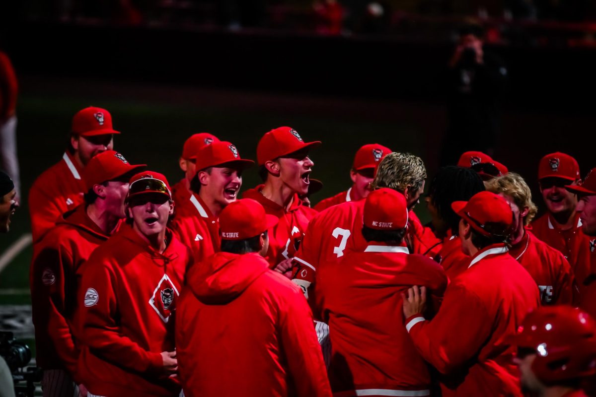 The team celebrates a home run by Christian Serrano during the second game of the doubleheader against Miami in Doak Field at Dail Park on Friday, May 1, 2026. The Wolfpack beat the Hurricanes 13-6.