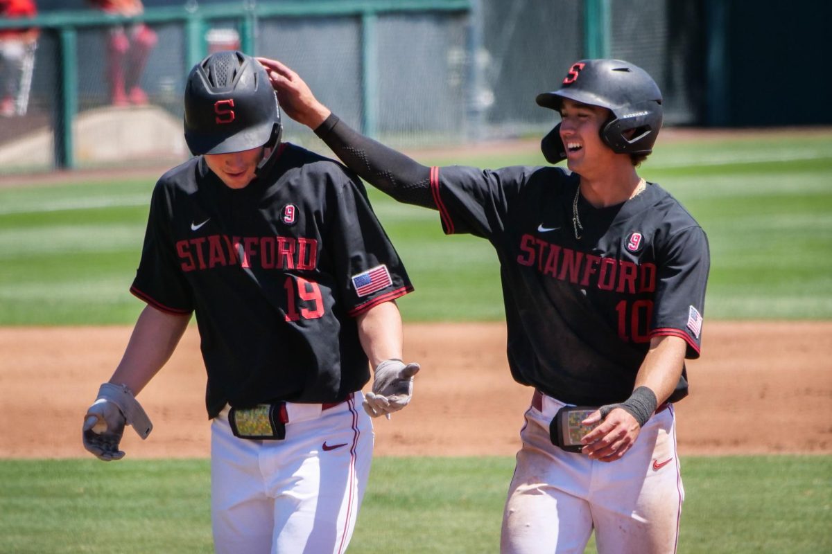 Freshman infielder Teddy Tokheim and sophomore infielder Charlie Bates laugh during the game against NC State at Klein Field at Sunken Diamond on Sunday, May 10, 2026. The Cardinal defeated the Wolfpack by a score of 9-5.