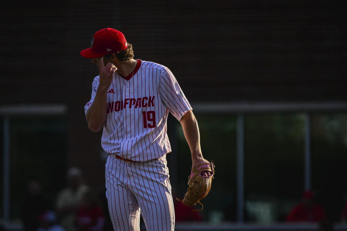 Junior right-handed pitcher Heath Andrews wipes his brow during the game against UNC in Doak Field at Dail Park on Thursday, May 14, 2026. The Tar Heels defeated the Wolfpack 9-4.