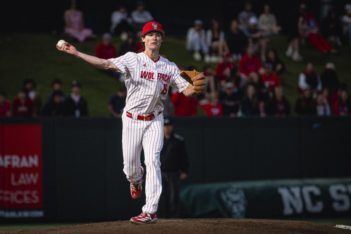 Junior right-handed pitcher Heath Andrews makes a pickoff attempt during the game against UNC in Doak Field at Dail Park on Thursday, May 14, 2026. The Tar Heels defeated the Wolfpack 9-4.
